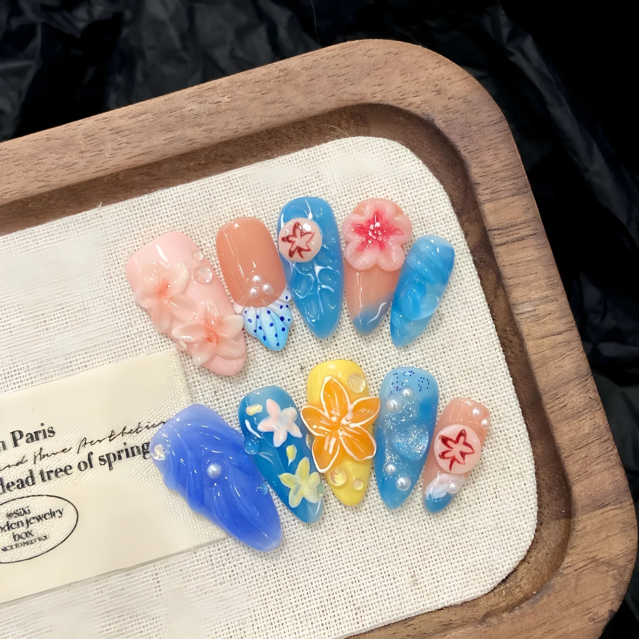 Plastic wearable armour with a carved three-dimensional jellyfish design in almond nail colour.