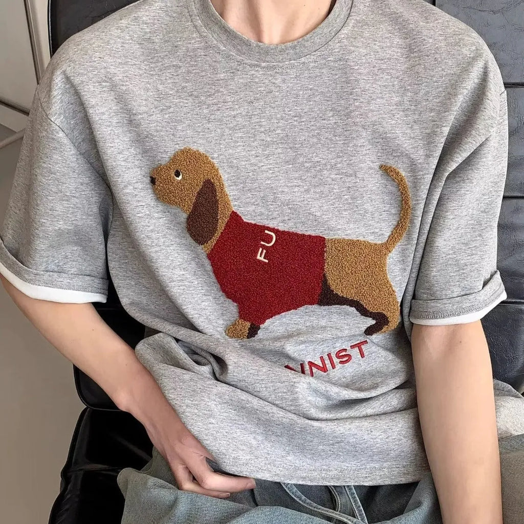 Men's grey cotton t-shirt with embroidered sausage dog holding towel design showing front view
