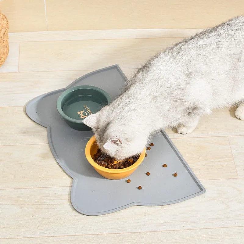 Blue silicone pet feeding mat with raised border for dog and cat food bowls