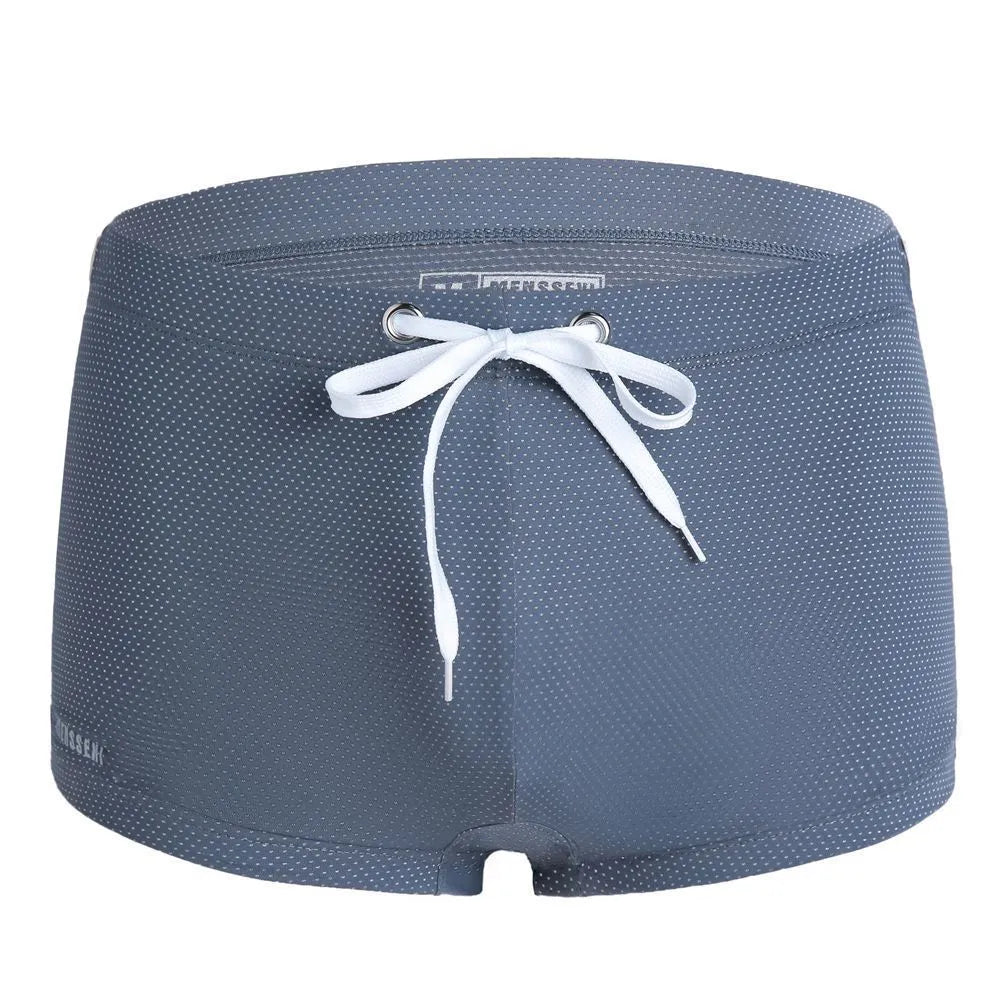 Men's low-waist boxer style swimming trunks in nylon, available in multiple colours.