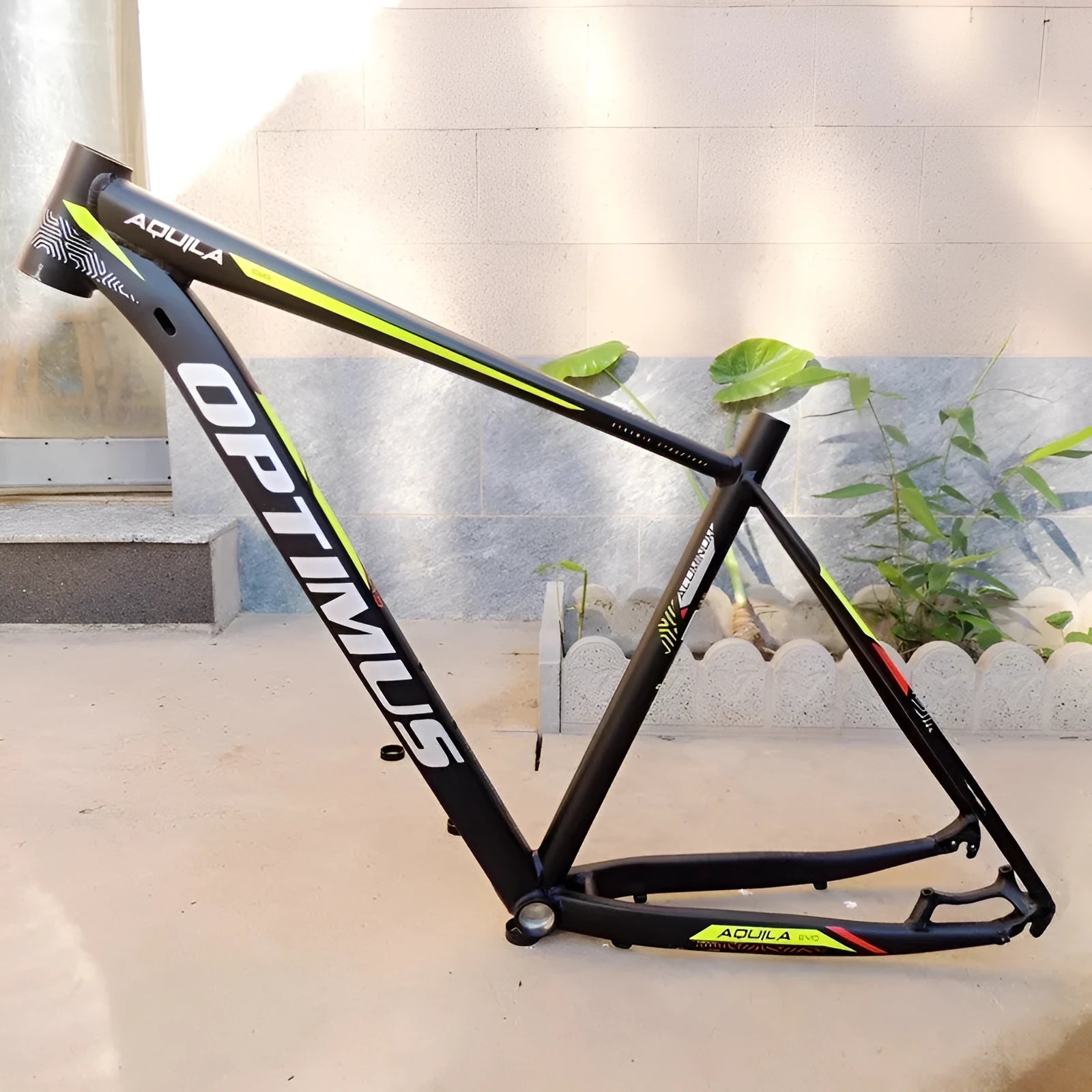 Black green 29-inch aluminium mountain bike frame showing internal cable ports and disc brake mount.
