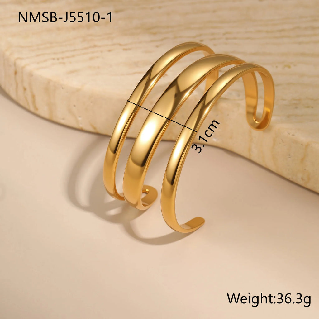 Women's stainless steel geometric bracelet with simple opening in gold or steel electroplated finish.
