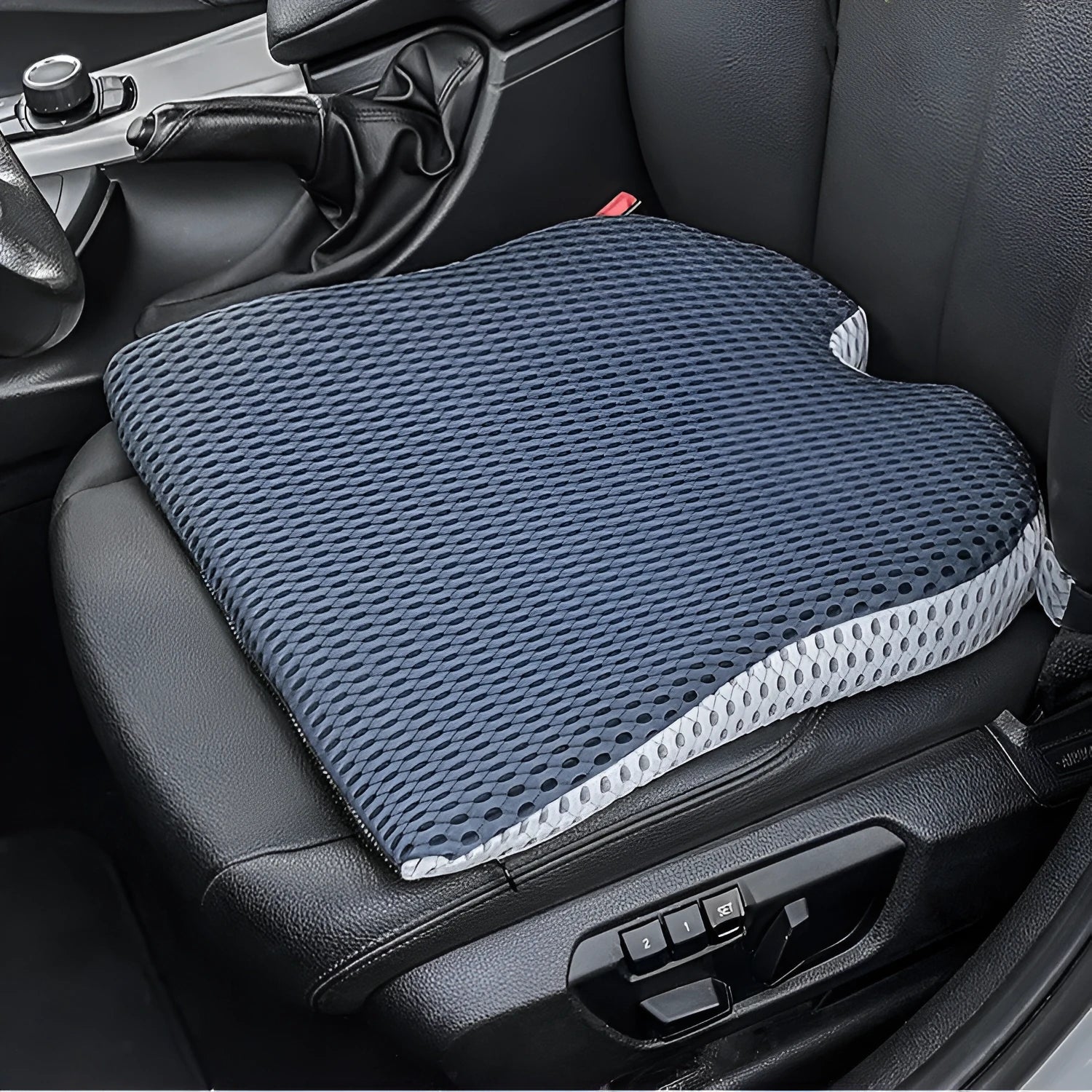 Memory foam car cushion with attachment straps in solid black colour on a car seat