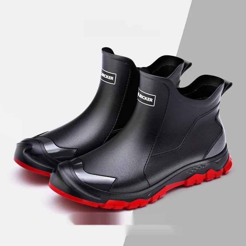 Short black PVC wading boots with a round toe and flat heel on a white background.
