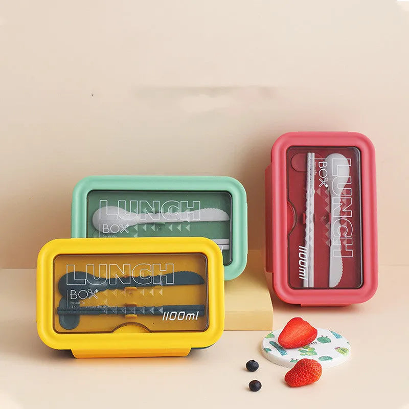 Green partitioned bento box with four food compartments showing Nordic design