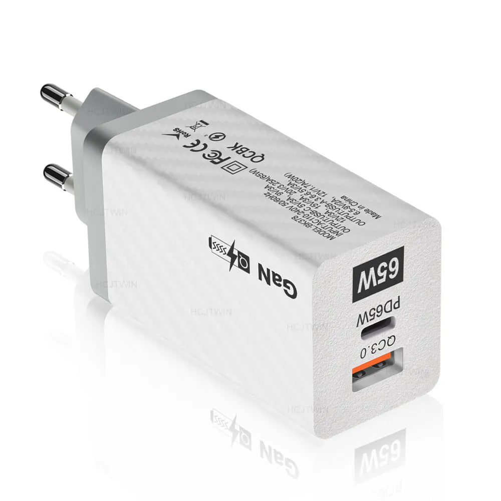 65W GaN fast charger showing compact size next to laptop with USB-C cable