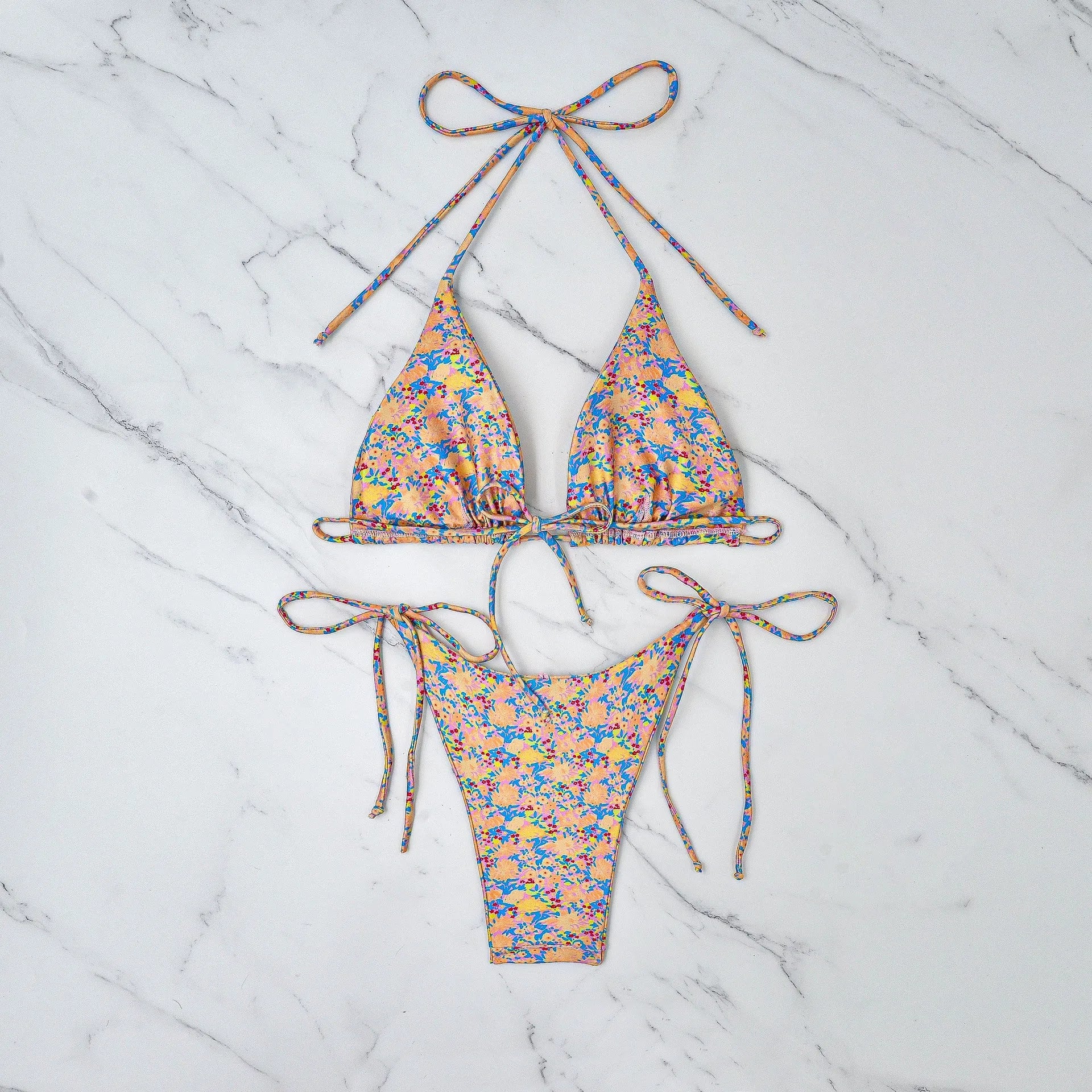 Women's lace-up bikini swimsuit in picture colour, showing backless design and high elasticity fabric.
