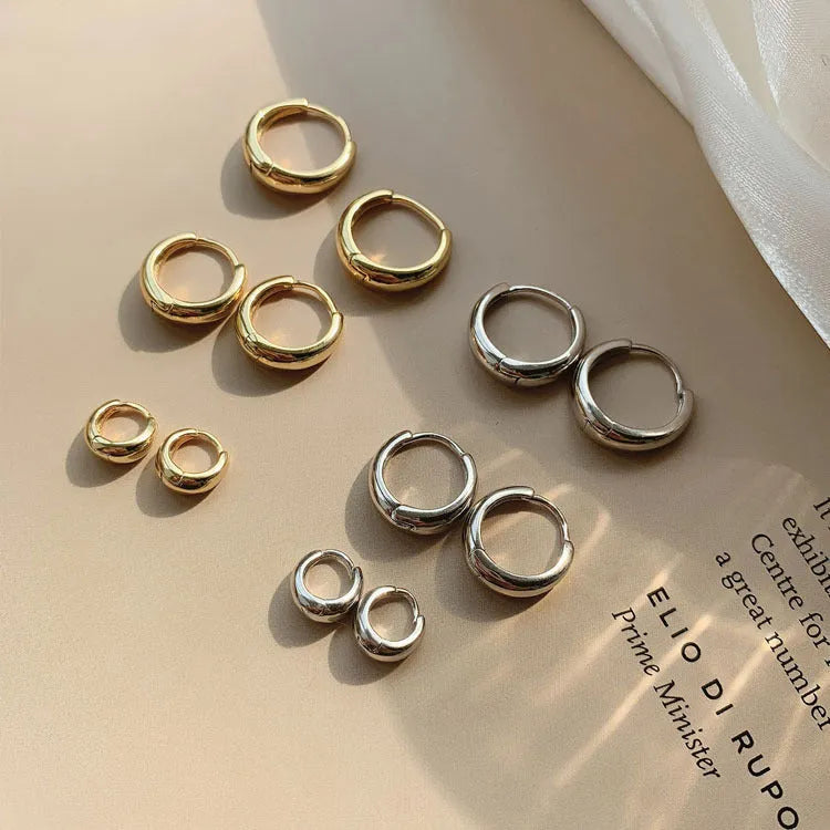 Women's geometric water drop earrings in gold or silver finish, shown in large, medium, and small sizes.