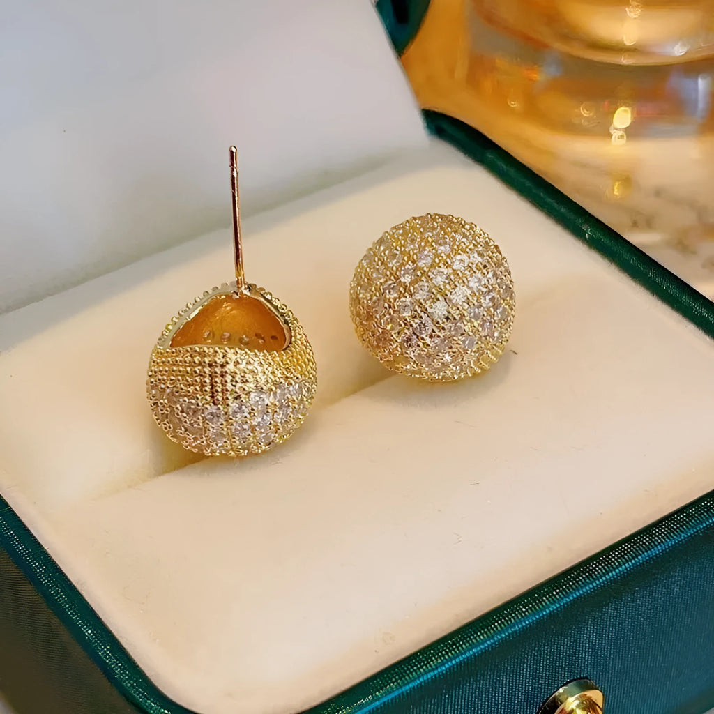 Geometric drop-shaped diamond ear clip earrings in gold and white colours with spherical elements
