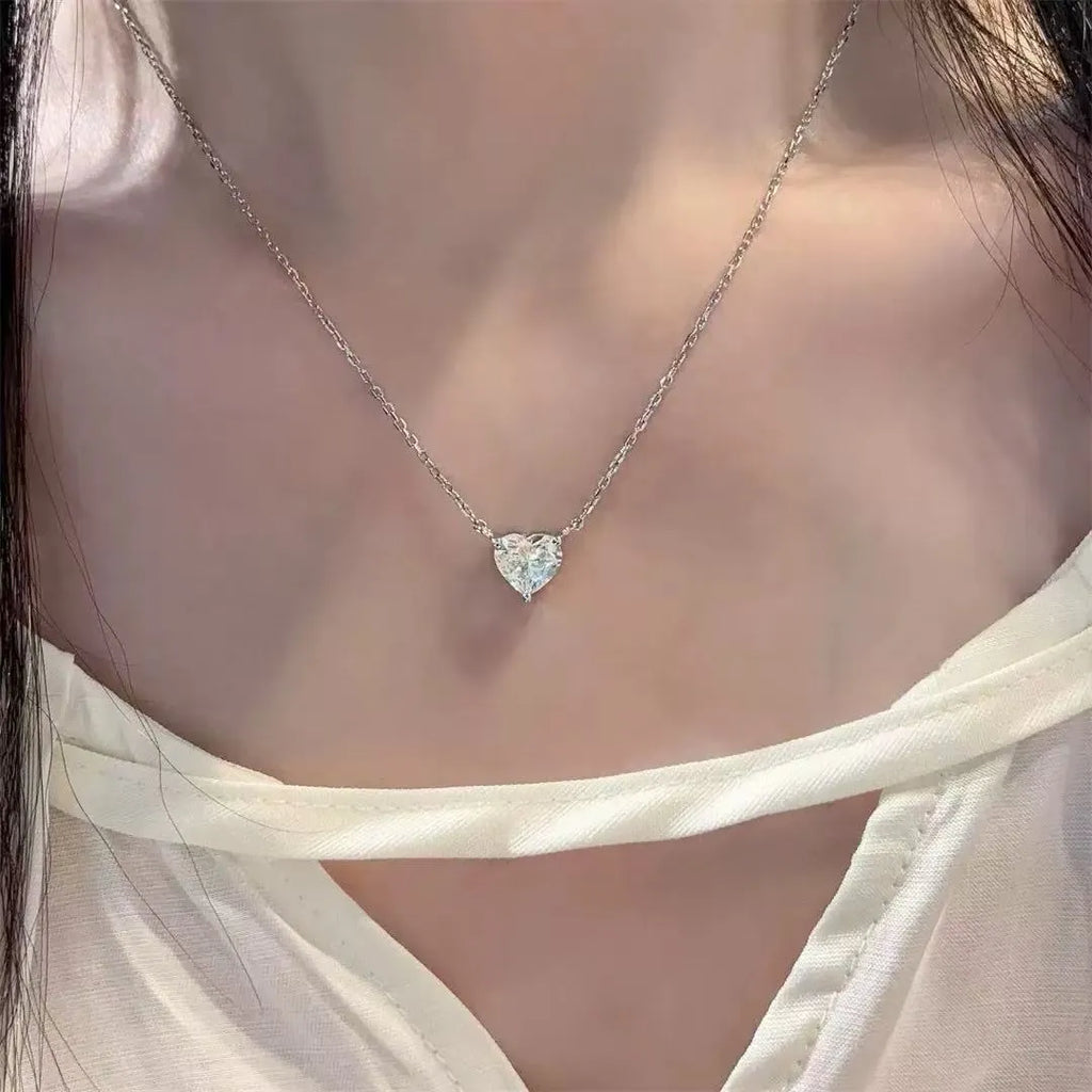 Silver women's heart necklace with simple refined design on copper chain