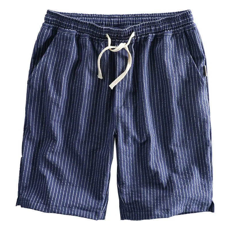 Man wearing striped casual cotton shorts with a loose straight fit and mid waist, showcasing the micro elastic fabric.