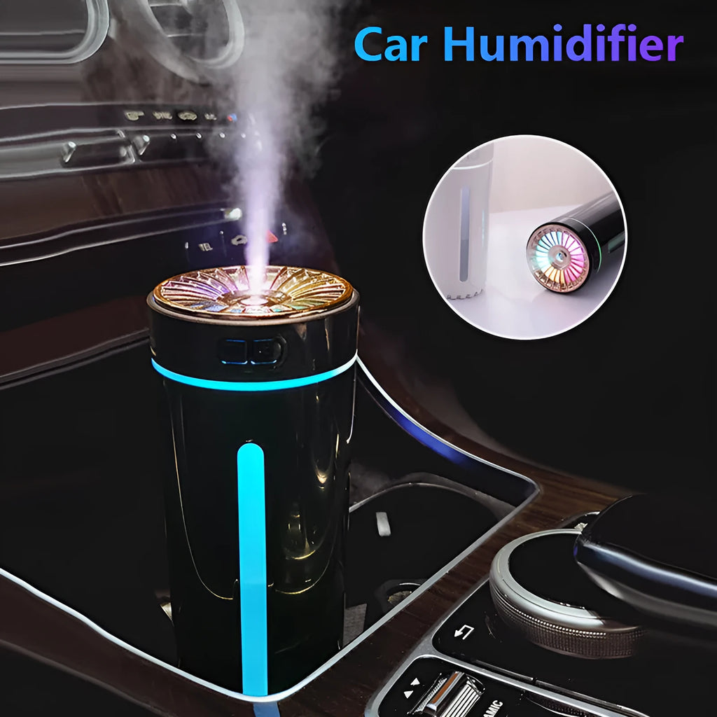 Black portable wireless ultrasonic humidifier with colourful LED lights on a car cup holder.