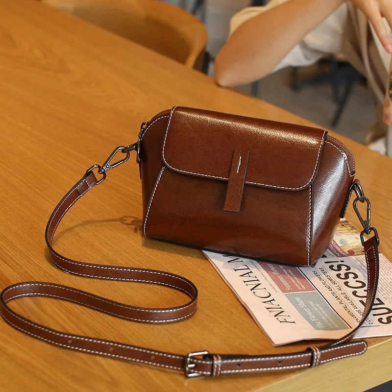 Brown genuine oil wax leather women's messenger bag with shell shape and single cross-body strap