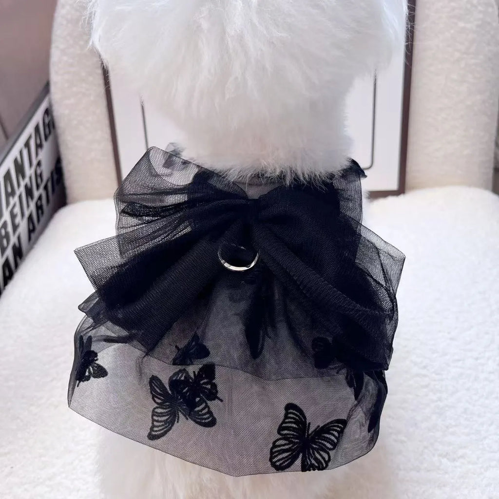 Black polyester tulle princess skirt for a small dog or cat on a hanger.