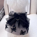 Black polyester tulle princess skirt for a small dog or cat on a hanger.