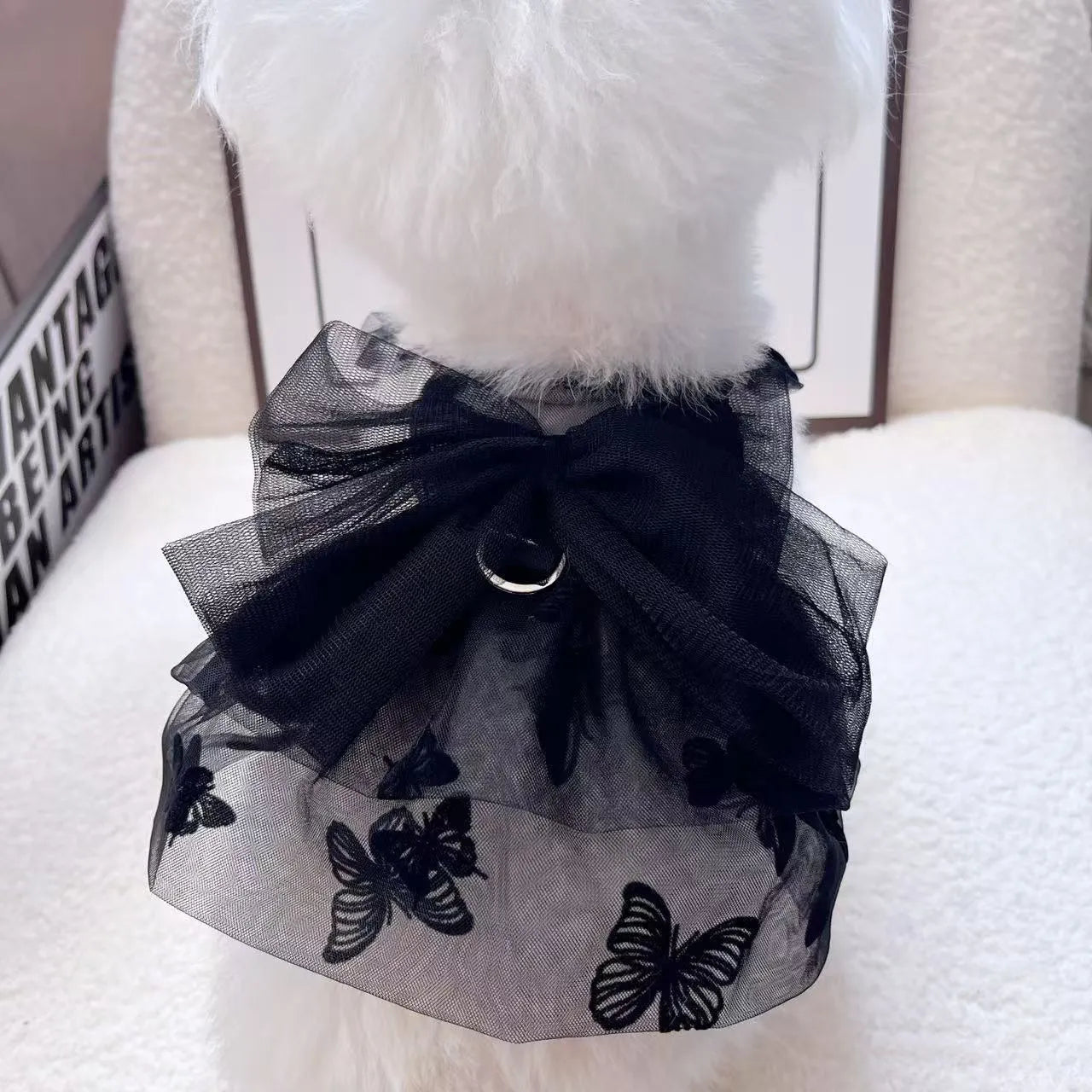 Black polyester tulle princess skirt for a small dog or cat on a hanger.