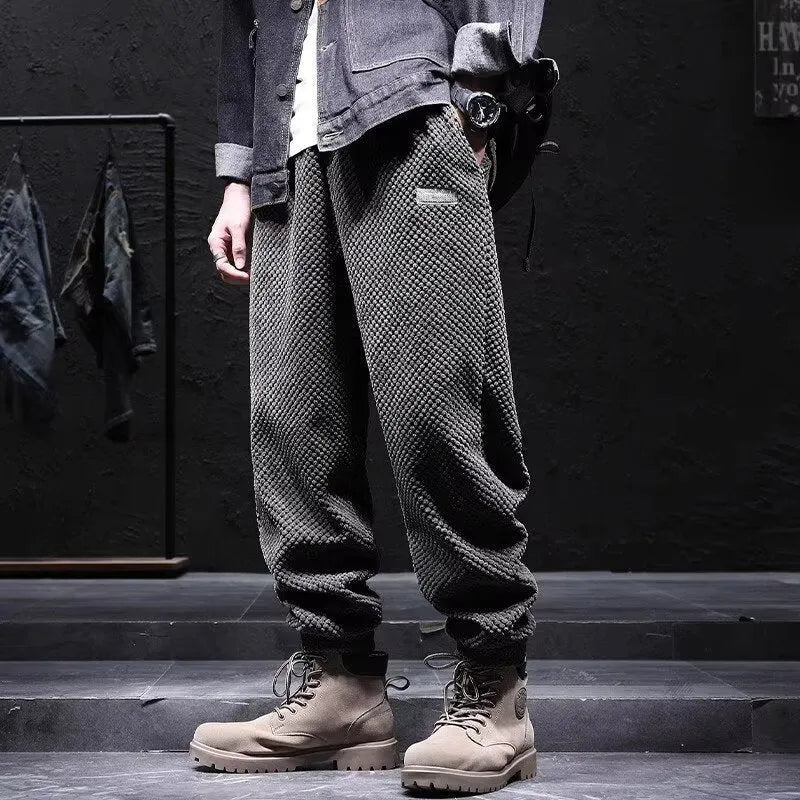 Men's grey straight-leg casual sweatpants with ankle strap detail on a hanger.