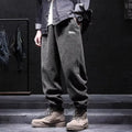 Men's grey straight-leg casual sweatpants with ankle strap detail on a hanger.