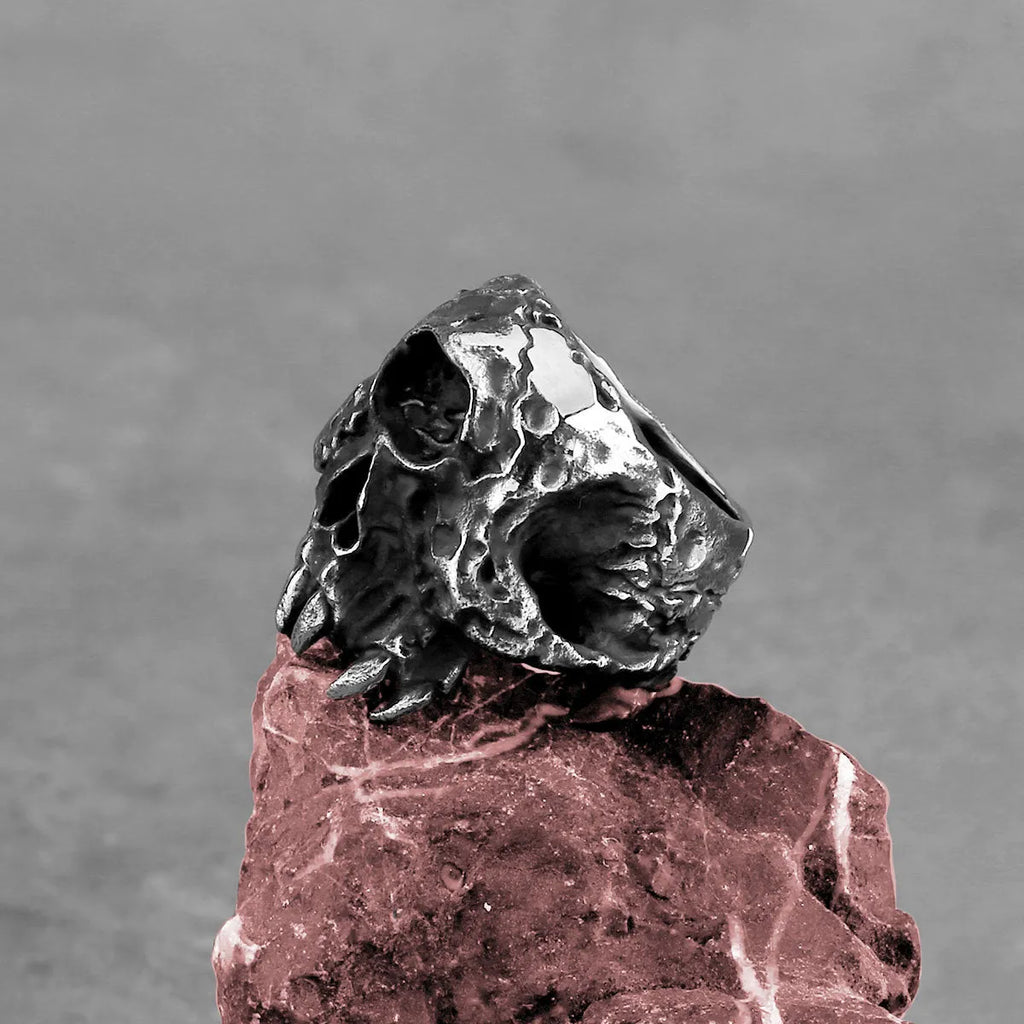 Alloy skull ring with one-eyed design and electroplated metallic finish shown on hand