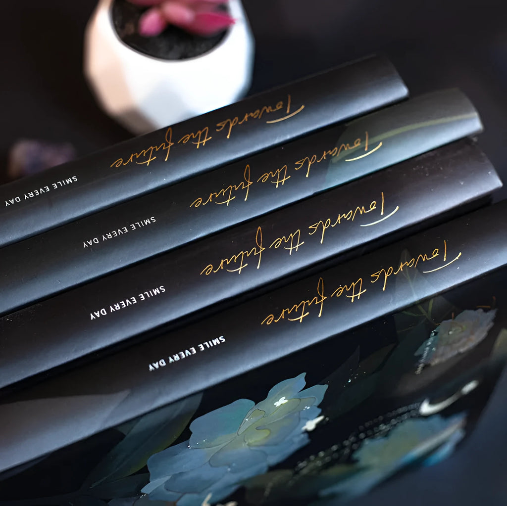 A5 notebook with luminous cover open to show pages filled with colour illustrations