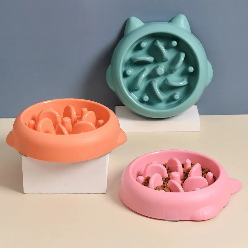 Green pet slow feeder bowl with raised internal ridges to slow eating for dogs and cats.
