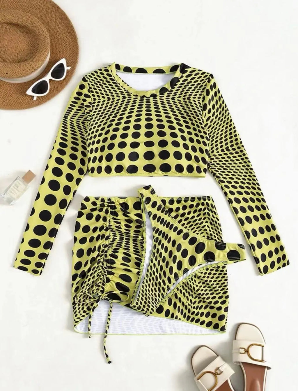 Women's green polka dot swimsuit three-piece set showing halterneck top and skirt