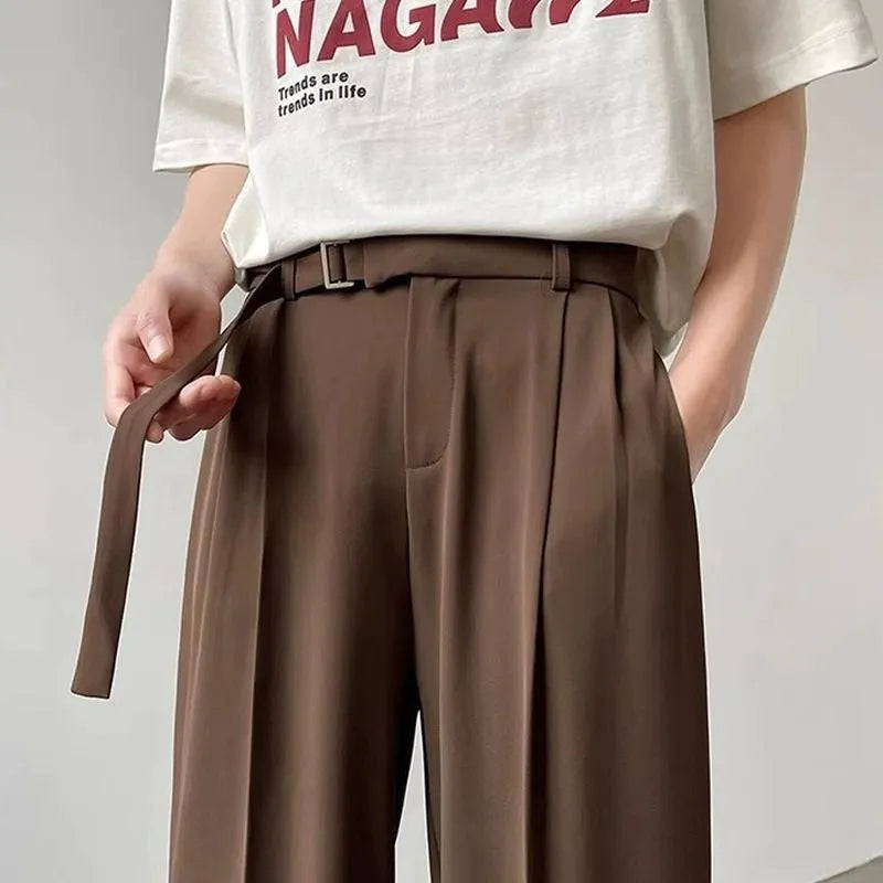 Black loose-fit wide-leg trousers with straight cut on a hanger.