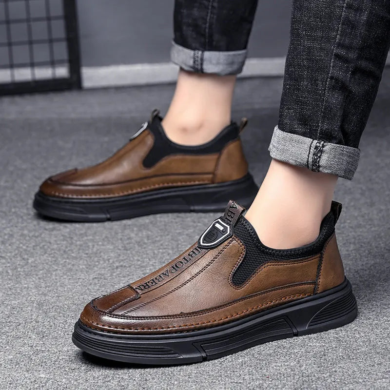 Men's black leather casual shoes with round toe on a plain background.