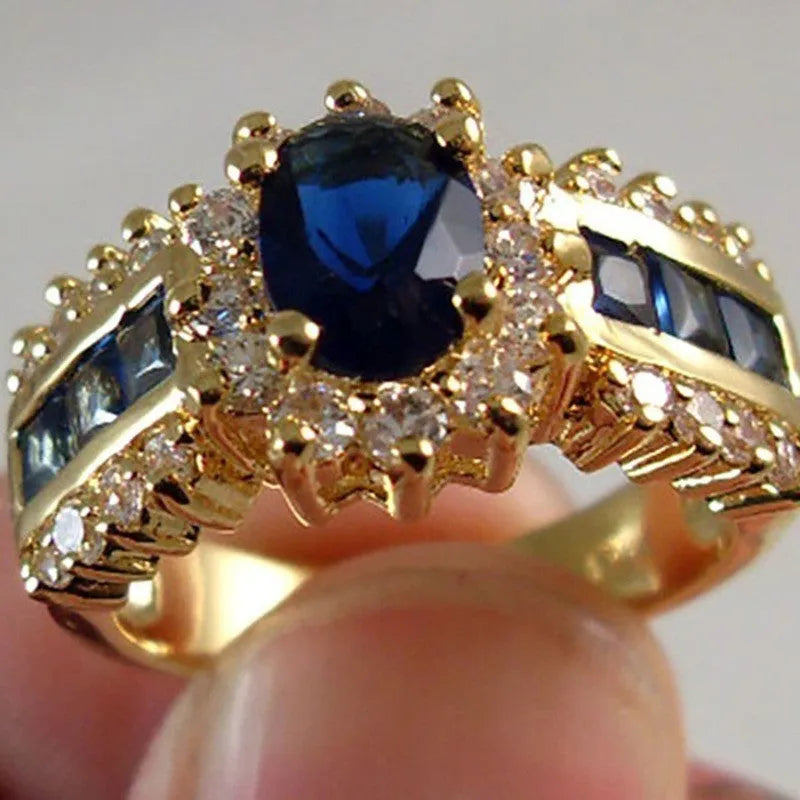 Zinc alloy personalised ring showing sunflower blue diamond and square-cut blue and purple zircon designs.