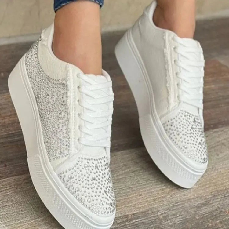 Women's black casual sneakers with rhinestone lace-up detail and a thick flat rubber sole.