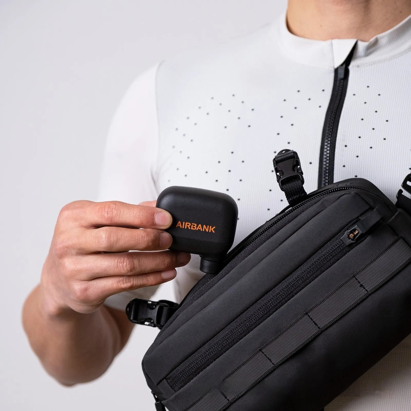 Black AS100 mini electric bicycle pump with USB cable and waterproof storage bag.