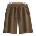 Cotton micro-elastic straight leg summer shorts for men and women on a neutral background.