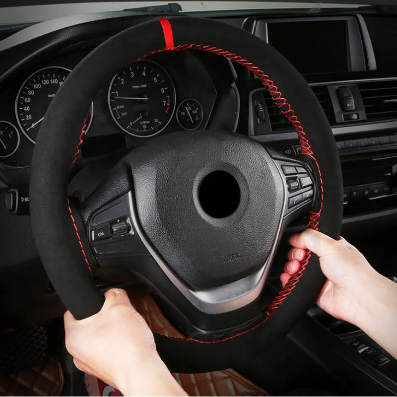 Black and red suede steering wheel cover fitted on a 38cm diameter car wheel.