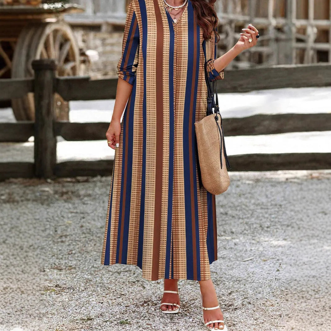 Camel-colour women's knitted V-neck dress with vertical stripes and long A-line skirt.