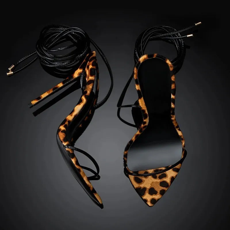 Women's leopard print Roman gladiator sandals with lace-up straps and a pointed toe.