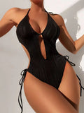 Women's black triangle bikini swimsuit with lace-up front closure on mannequin