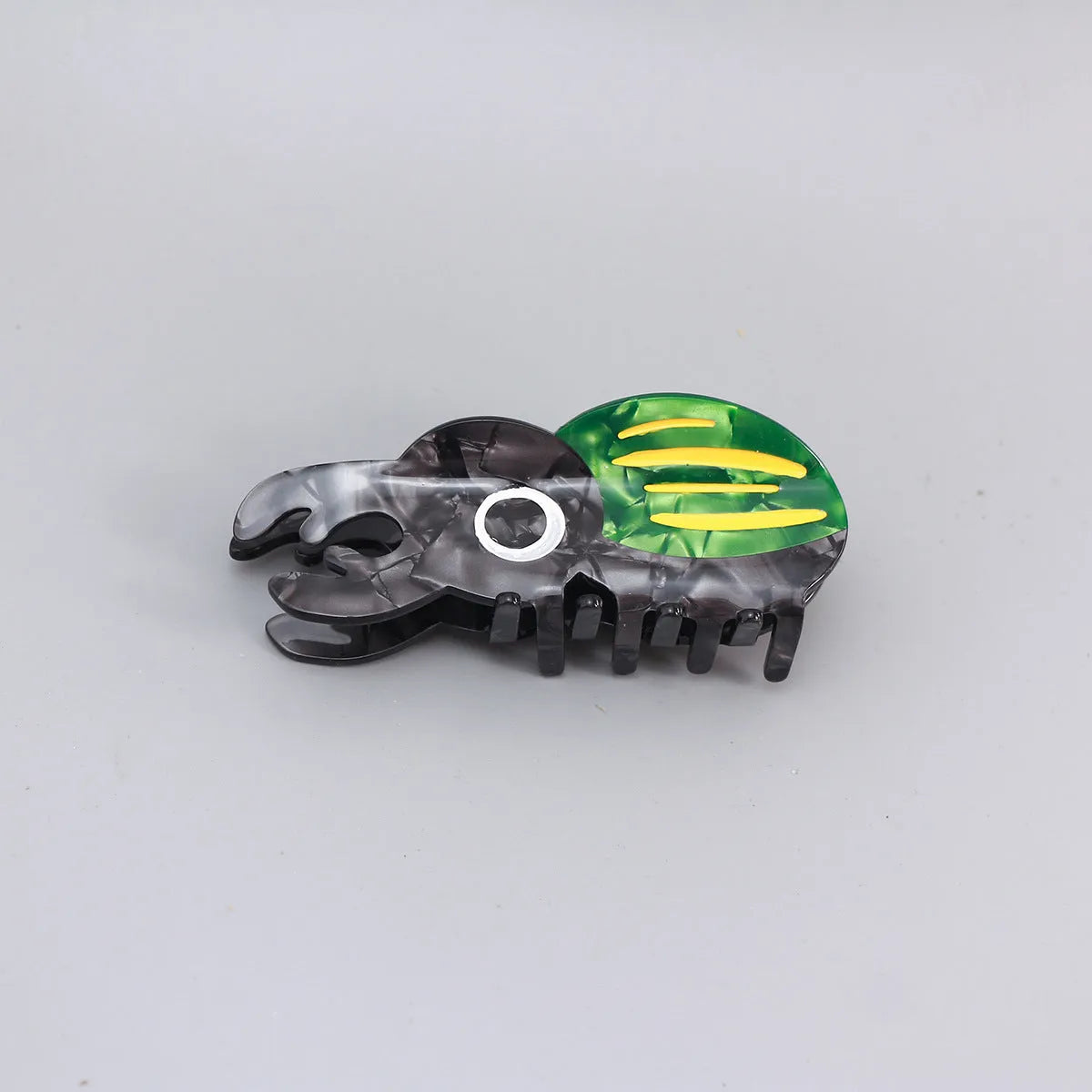 Handmade cellulose acetate Beetle Grip educational tool showing cartoon beetle and caterpillar designs