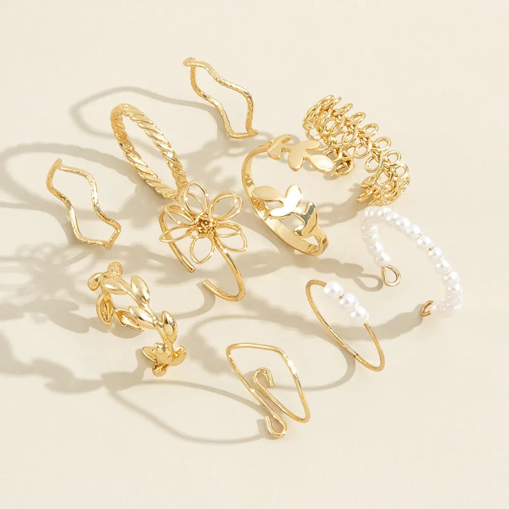 Women's alloy openwork flower ring with glossy electroplated gold finish