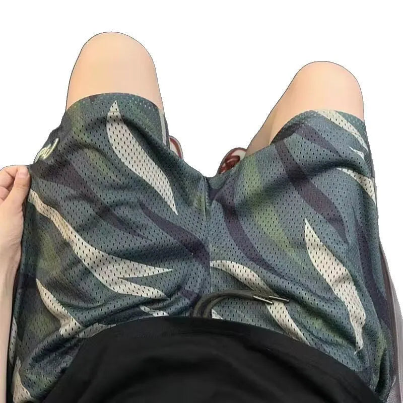 Men's straight-leg camouflage shorts in cotton blend fabric on a plain background
