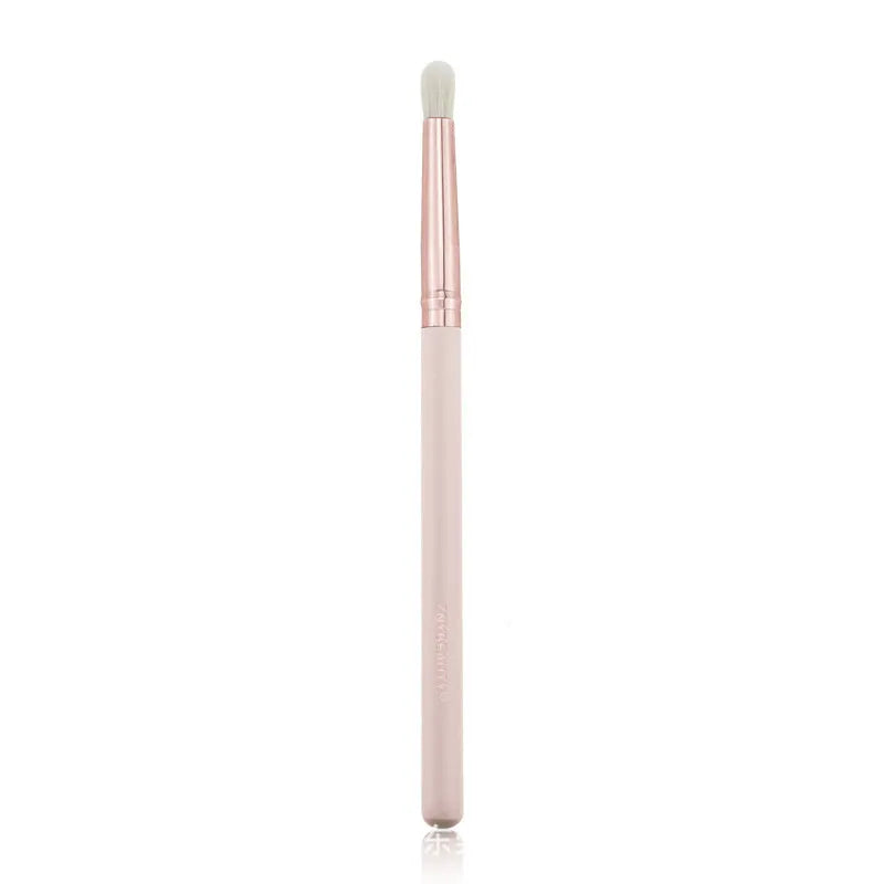 26 pink makeup brushes with wooden handles laid out next to a matching storage bag.