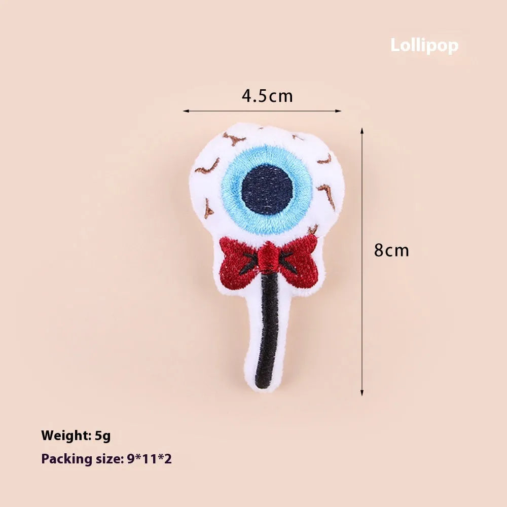 Small plush cat teaser wand with colourful eyes candy skull designs and feathers