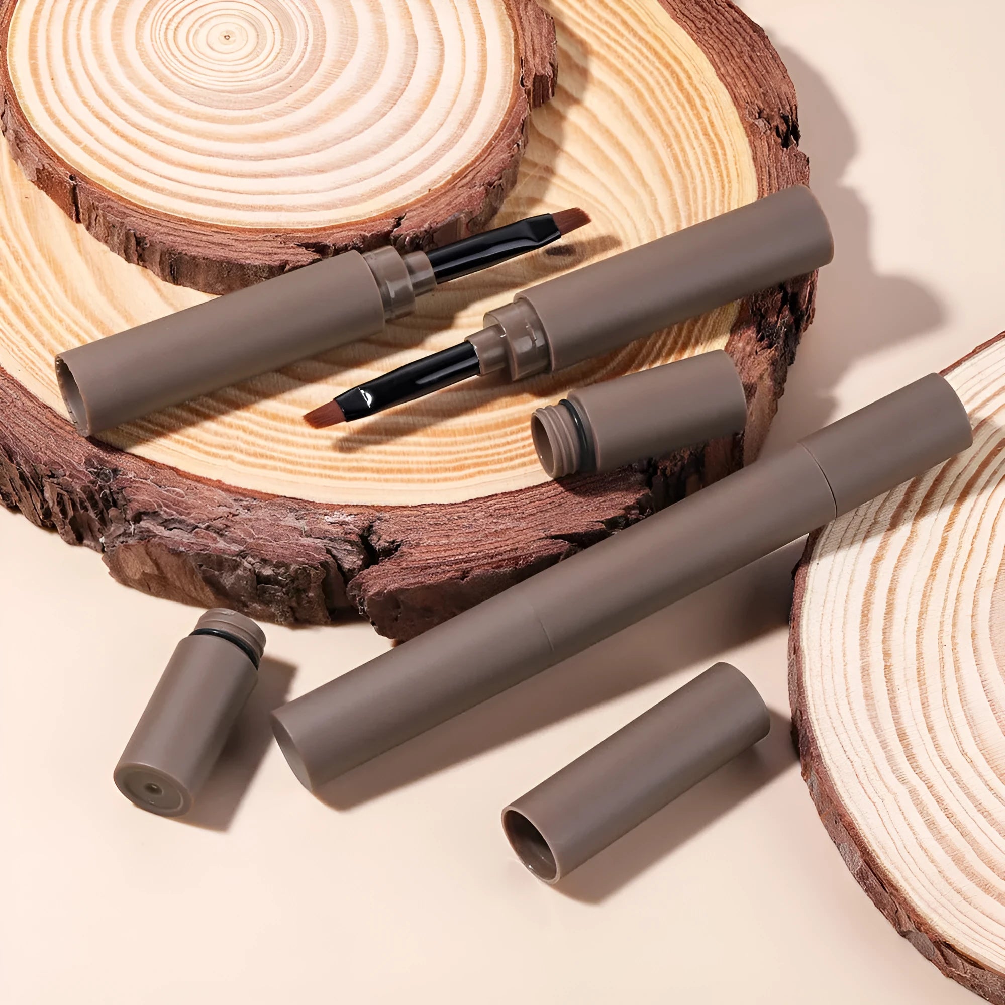 Double-headed eyebrow cream tube showing pencil and powder ends, with colour options reddish brown, brown, light brown, dark brown, and black.