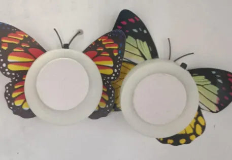 12 butterfly LED night lights with auto-change colours and suction pad on a surface