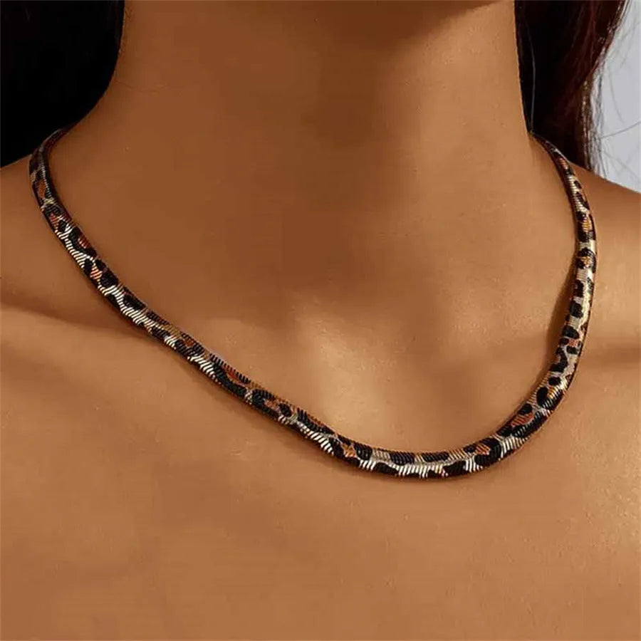 Women's alloy leopard necklace with leopard print motif against a neutral background