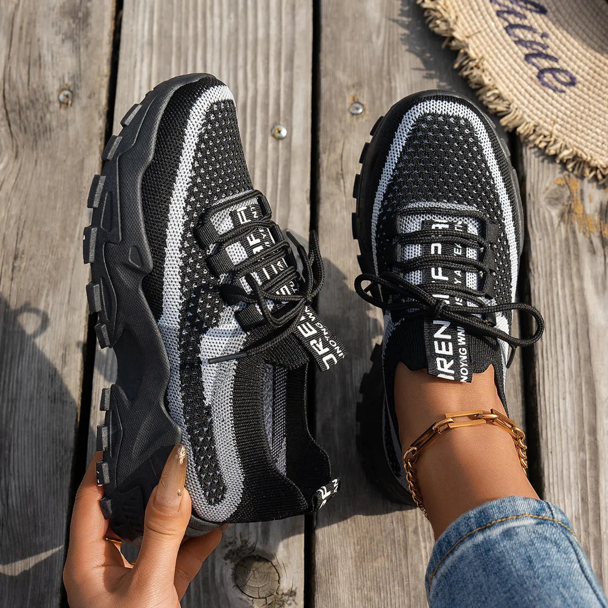 Women's low heel Flyknit mesh sneakers in a grey colour scheme with lace-up front.
