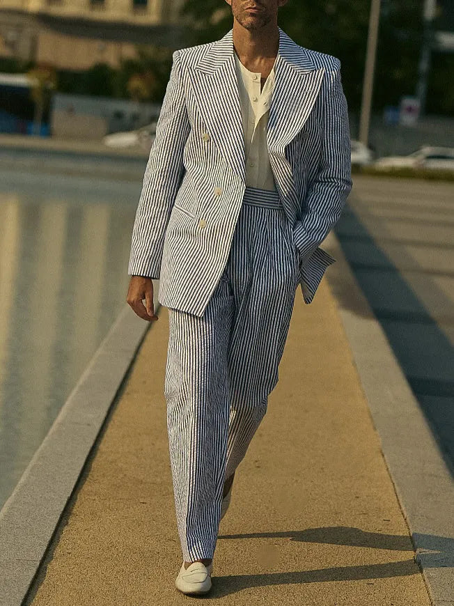 Blue and white striped polyester suit set with blazer and trousers on hanger