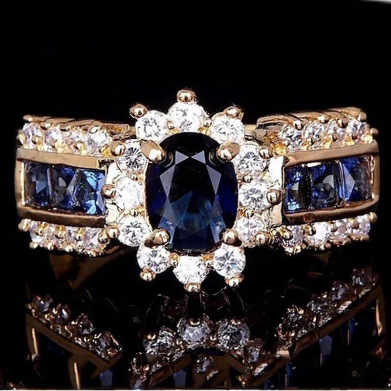 Zinc alloy personalised ring showing sunflower blue diamond and square-cut blue and purple zircon designs.