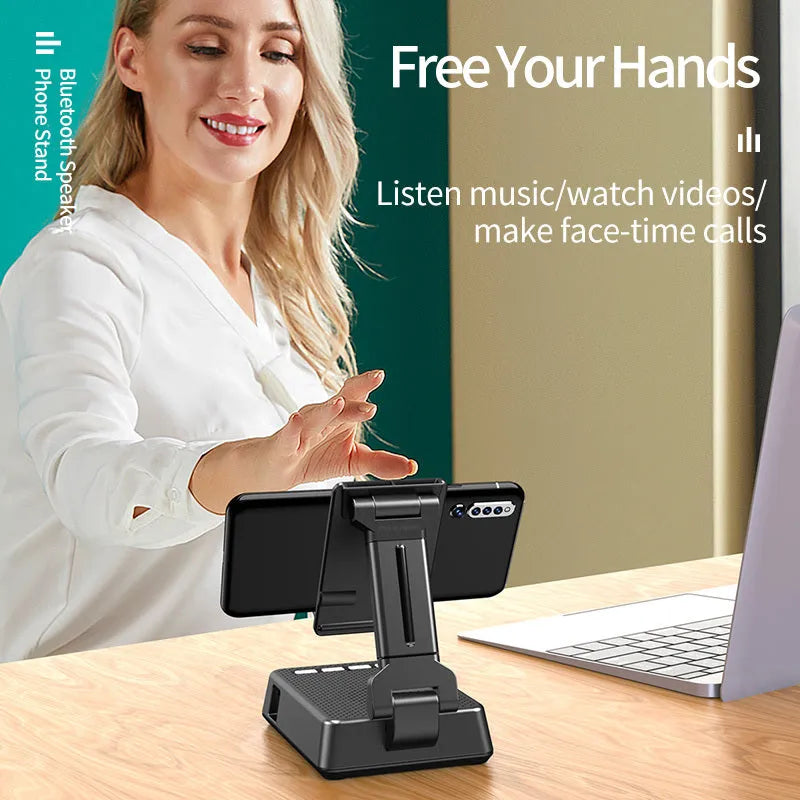 Black mobile phone broadcaster stand with Bluetooth speaker and microphone on desk