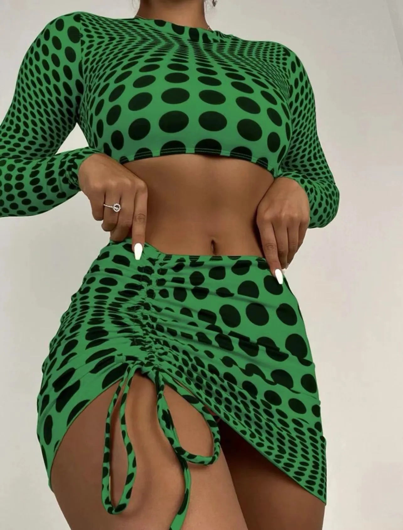 Women's green polka dot swimsuit three-piece set showing halterneck top and skirt
