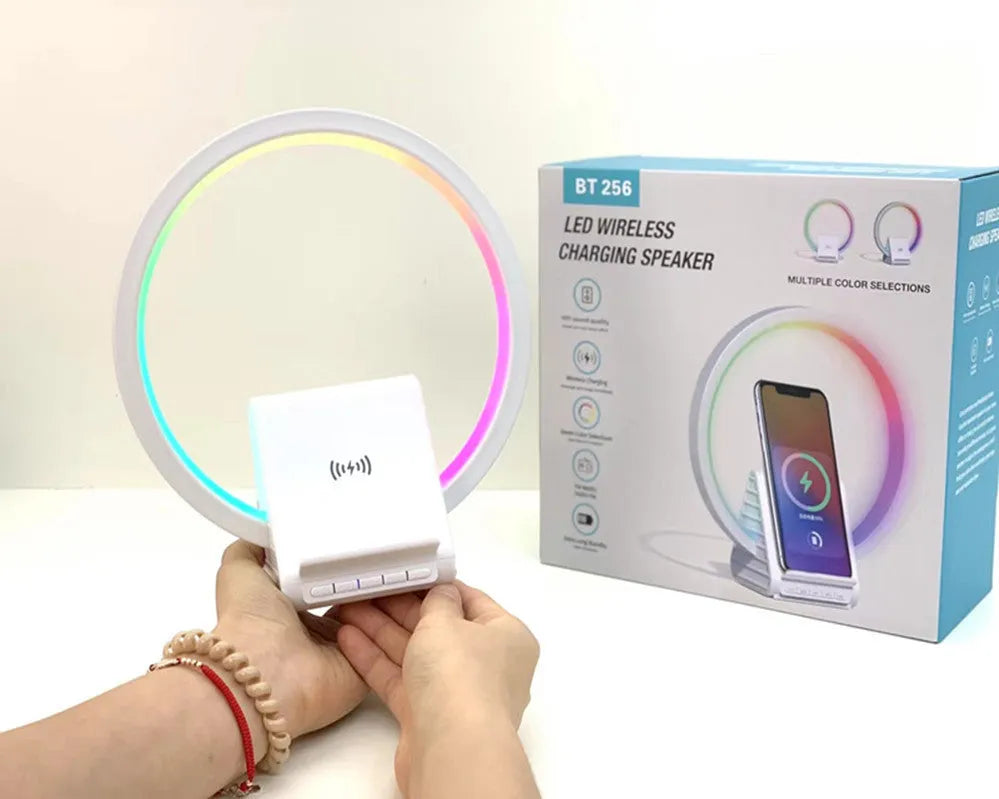White circular smart Bluetooth speaker with ambient lighting and wireless charging pad